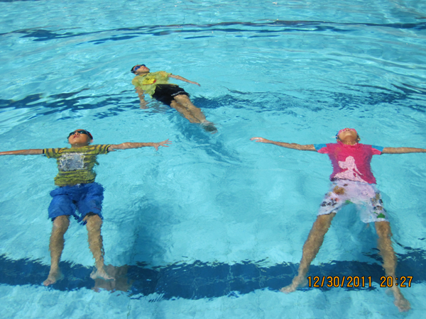 Kids Floating in Swimming Pool